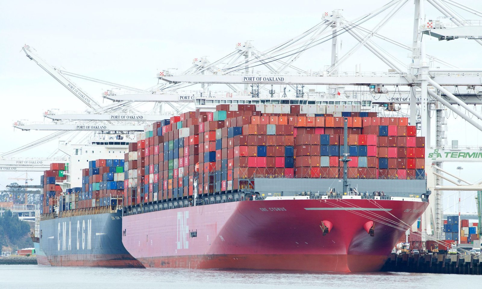 cargo ships loading at port of oakland
